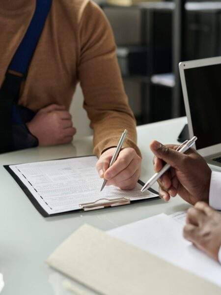 Injured man signing legal paperwork