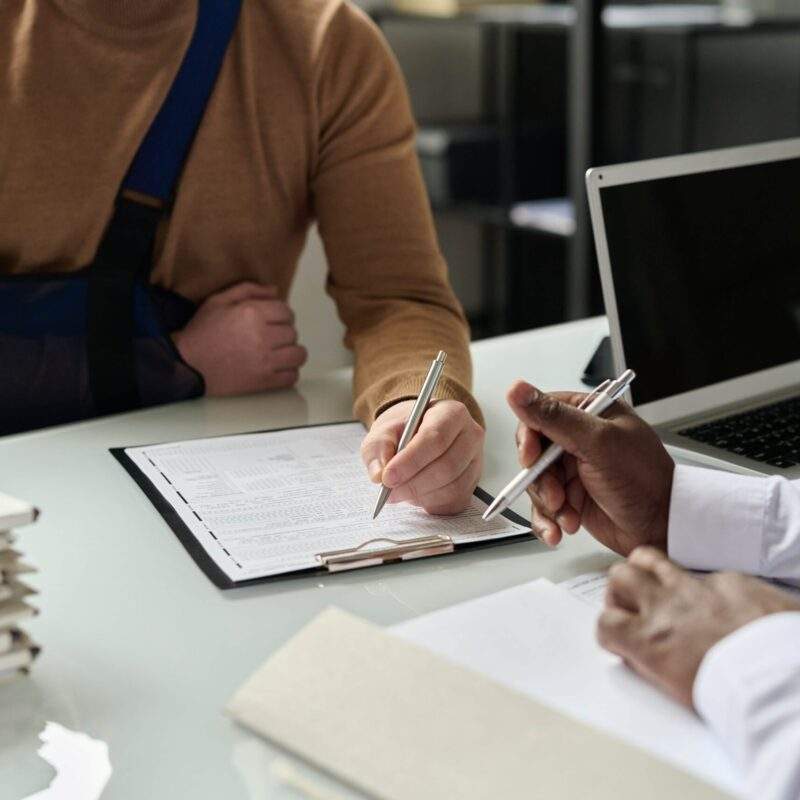 Injured man signing legal paperwork